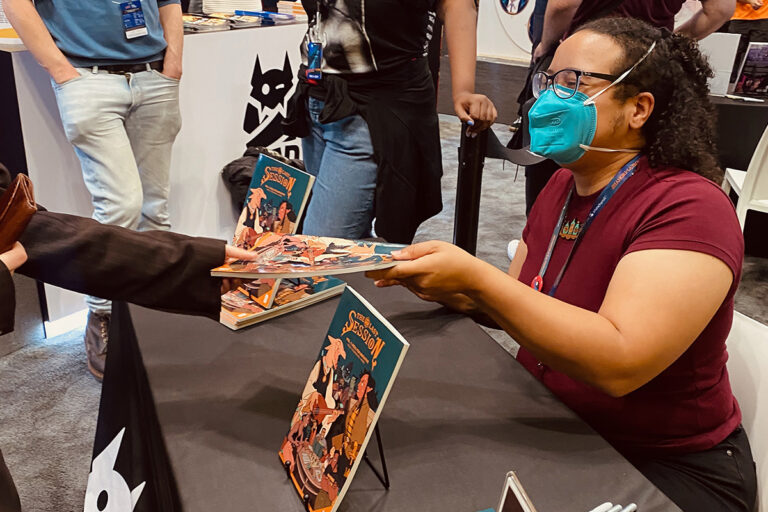 Jasmine Walls meeting a fan and signing a copy of The Last Session