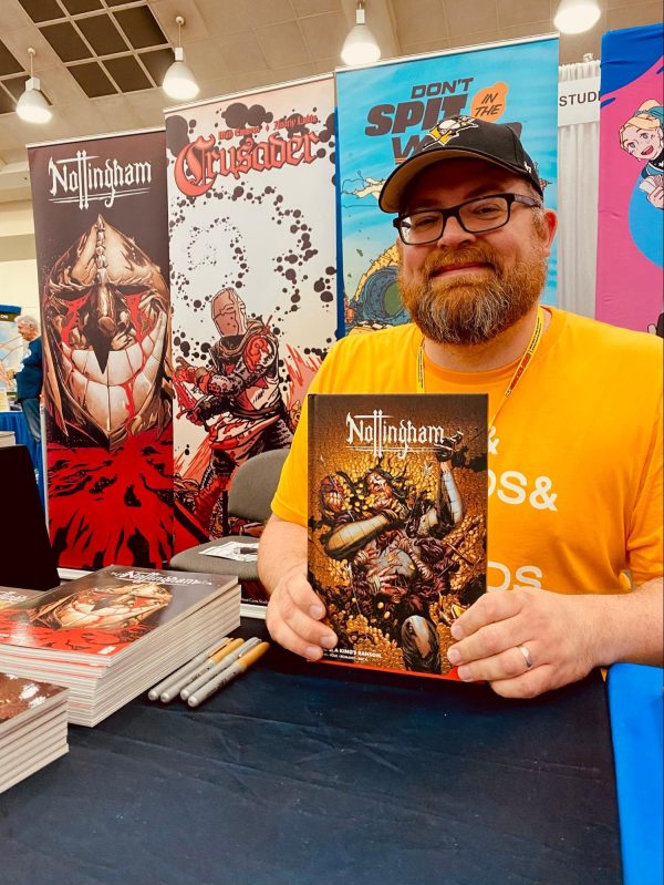 Ringo-nominated letterer Justin Birch signing copies of our hit medieval noir, Nottingham at Baltimore Comic Con 2023